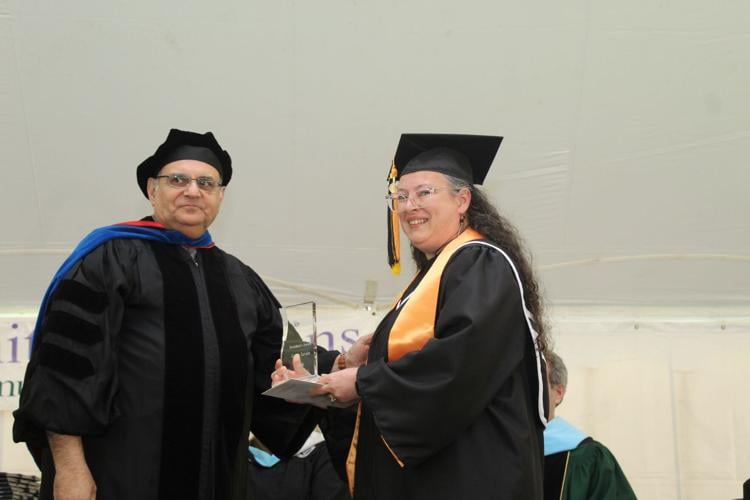 Aimee Lavoie (left) accepts the President's Award from WMCC President Sarmad Saman