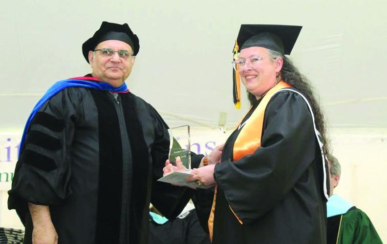 Aimee Lavoie (left) accepts the President's Award from WMCC President Sarmad Saman