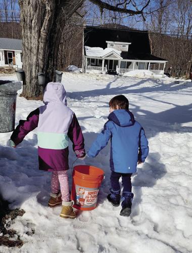 kids carrying bucket