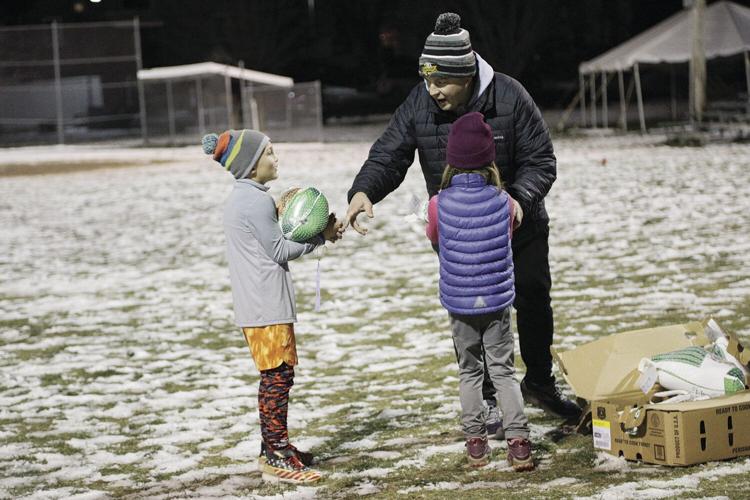 11-18-22 Conway Rec Turkey Trot 7-8 handing turkeys