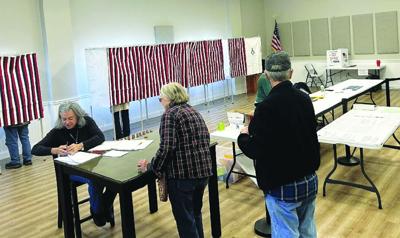 Nora Schwarz checks voters in