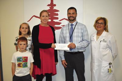 Lazaron presents check for music education