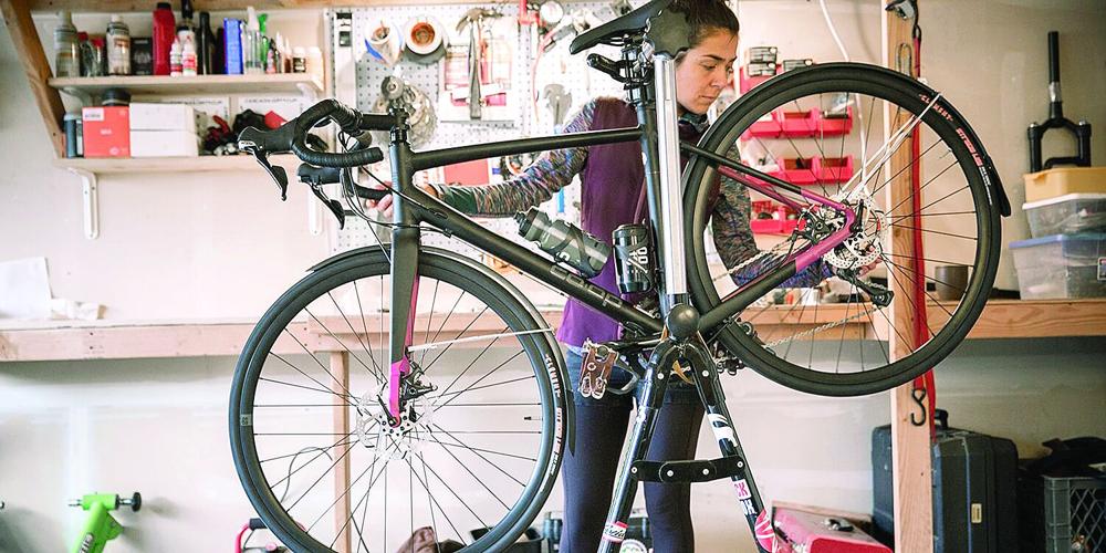 Wheel Family Fun - bike safety - cyclist checks her gears