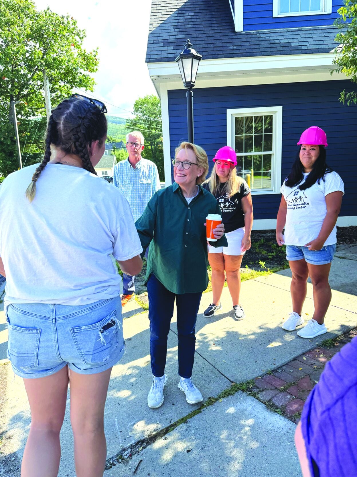 Sen. Maggie Hassan (center) shakes hands with Gorham Community Learning Center’s Julianne Gooden
