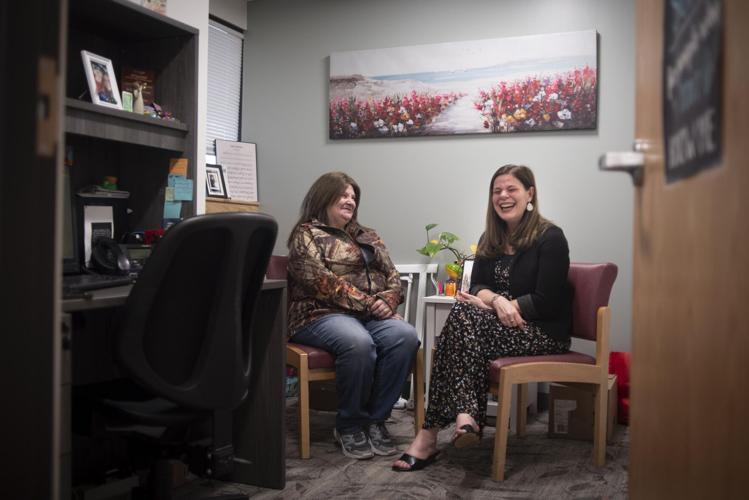 Cecile Belanger, 58, left, and medical social worker Bridget Laflamme laugh