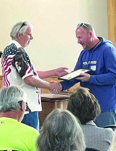 Selectman Kyle Copeland giving plaque vertical