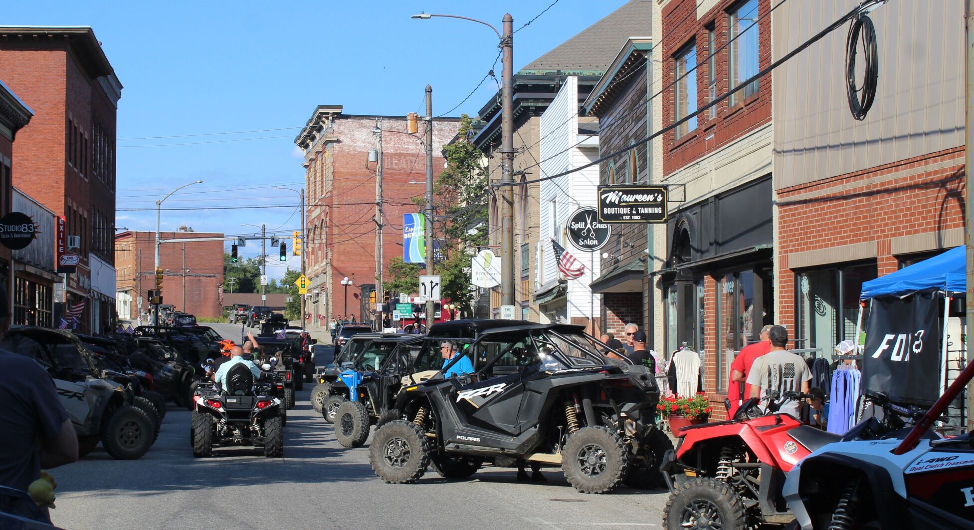 All-terrain vehicles, or ATVs, and outdoor enthusiasts line up along