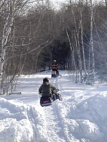 Jay Henry and Kevin Bennett on snowmobiles