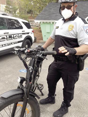 Wheel Family Fun - Kids' Bike Safety Day at Story Land - Chief Chris Perley displays bike