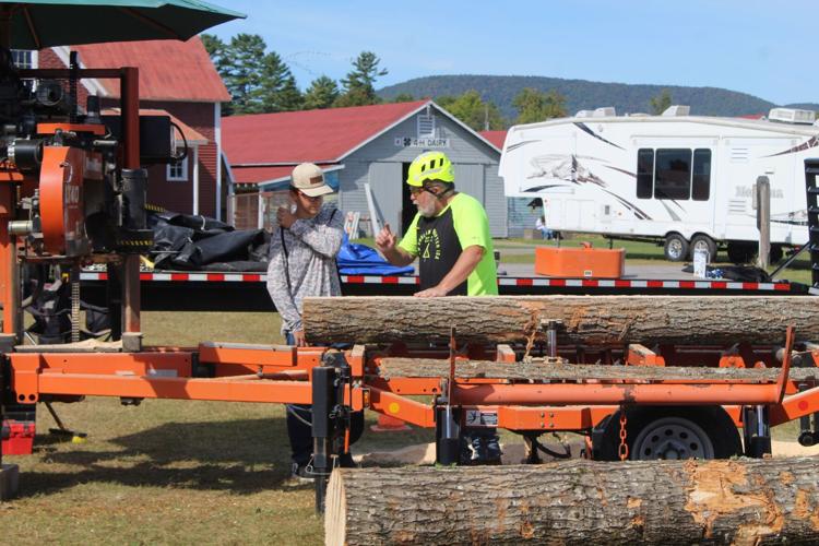 A student learns about cutting trees and boards using a portable sawmill