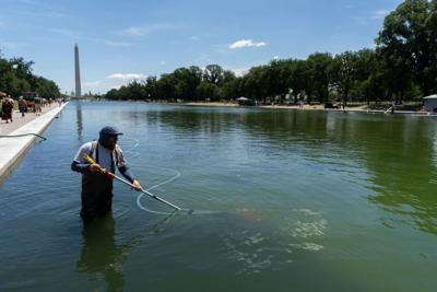 A National Park Service employee uses a vacuum to clean the Lincoln Memorial Reflecting Pool on June 20, 2026.