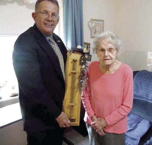 Then-mayor Paul Grenier presents the Cane of Wisdom to Berthe Gagnon