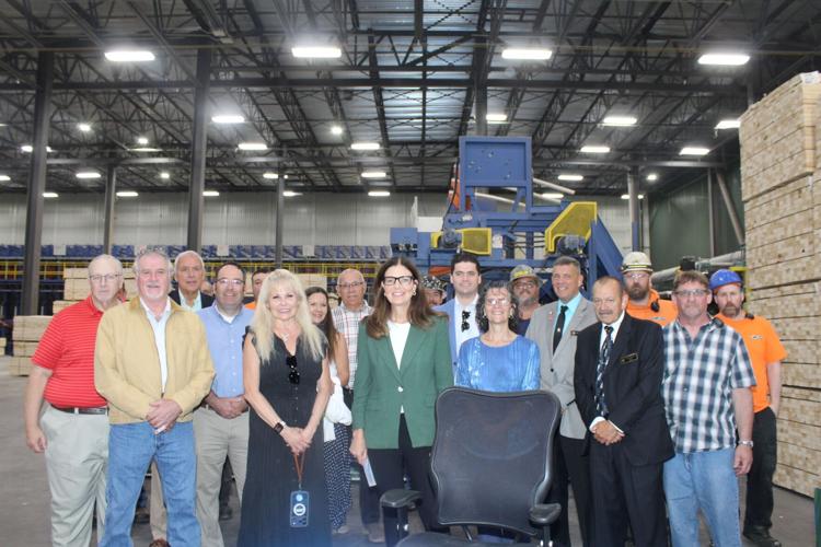 Elected officials, Milan Lumber Co. employees, guests, and Gov. Kelly Ayotte gather