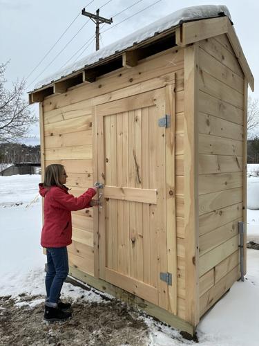 Magen Moreau checks the latch and door of the shed