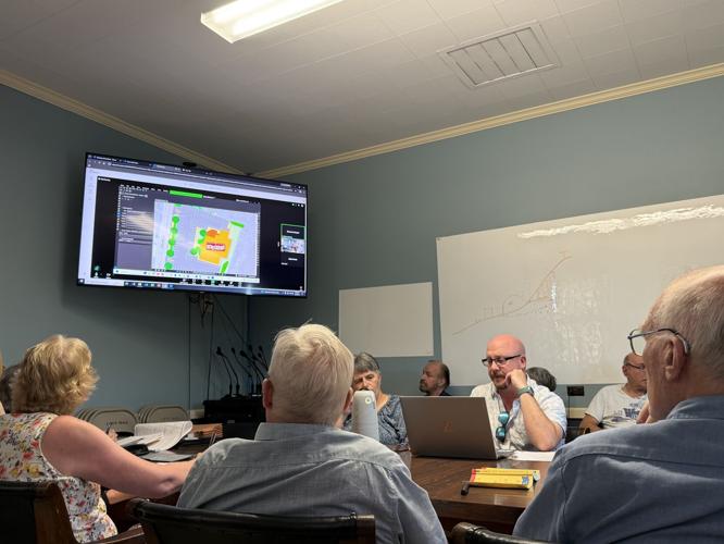 Civil engineer Brian Pratt (third from left, facing forward) reviews plans for Revo in Berlin
