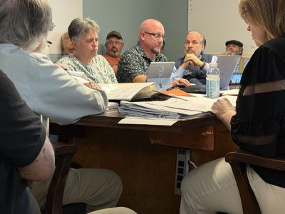 Civil engineer Brian Pratt (second from left at table) and Stefan Huba to Pratt's left
