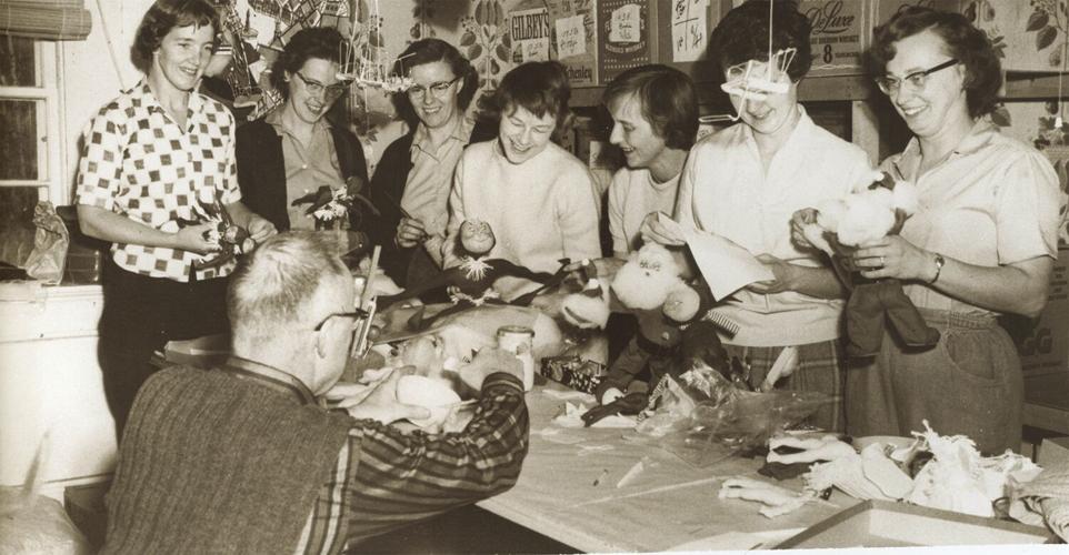 working on dolls in kitchen