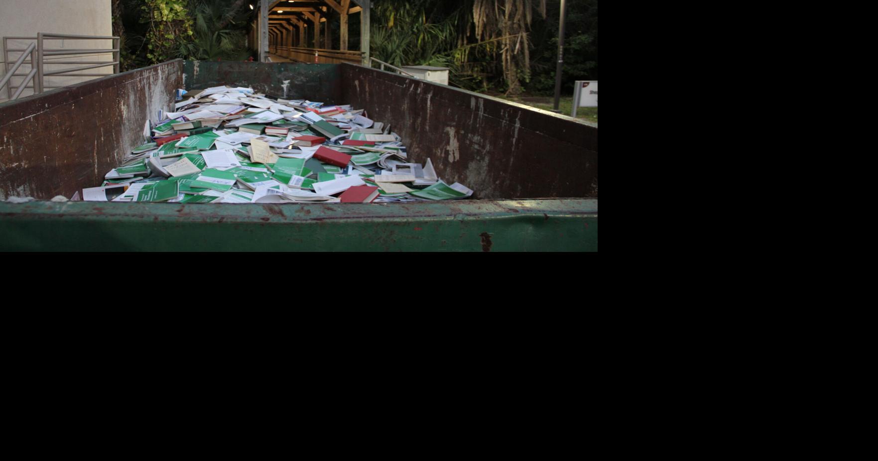 Parting with the past – dumpster filled with books outside Florida Tech’s Evans Library