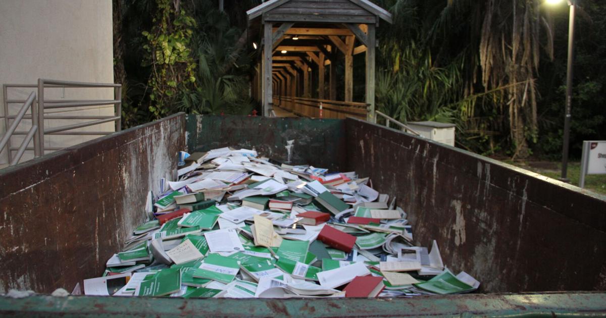 Parting with the past – dumpster filled with books outside Florida Tech’s Evans Library