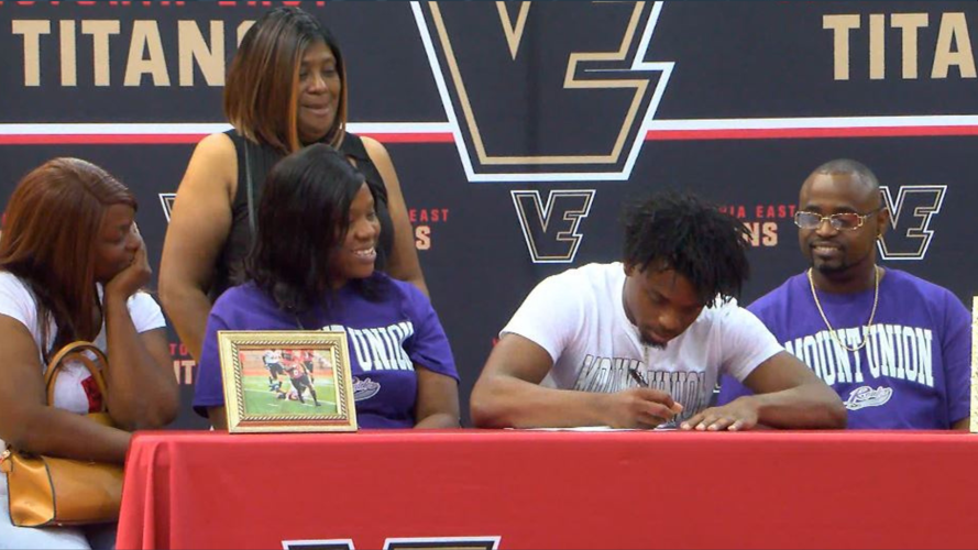 Giles signs letter of intent surrounded by family