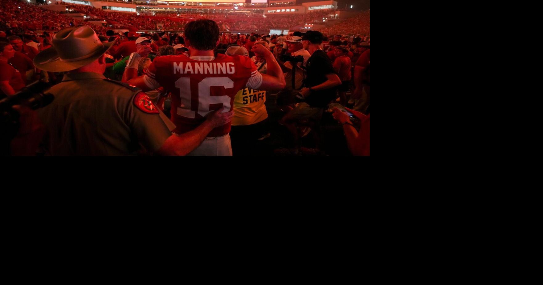 Fans celebrate with Texas quarterback Arch Manning (16) after the team's defeat of Ohio State at Darrell K Royal-Texas Memorial