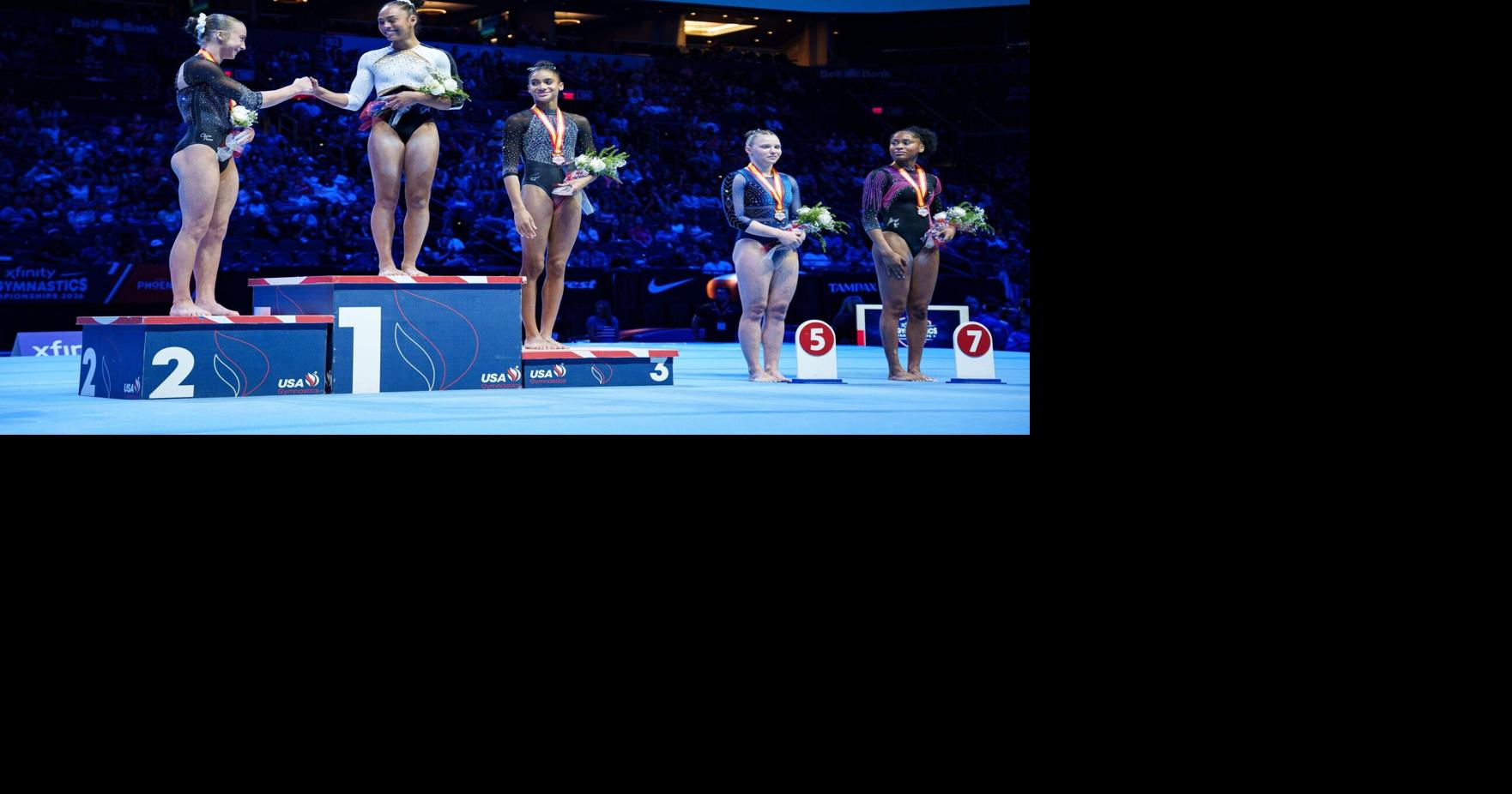 Second- and first-place winners Claire Pease (left) and Hezly Rivera (middle) greet each other on the podium after competing in the Xfinity U.S. Gymnastics senior women's championships at the Mortgage Matchup Center on Aug. 9, 2026, in Phoenix.