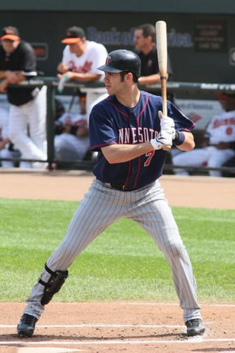 Former Minnesota Twins player Joe Mauer waves to fans after being