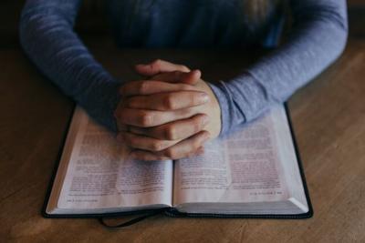Praying hands and Bible