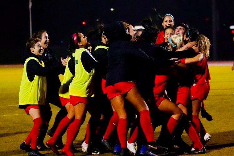 Women's Soccer Team celebrating the overtime goal to win the game.