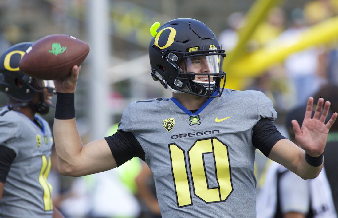 Justin Herbert of the Oregon Ducks looks to pass against the