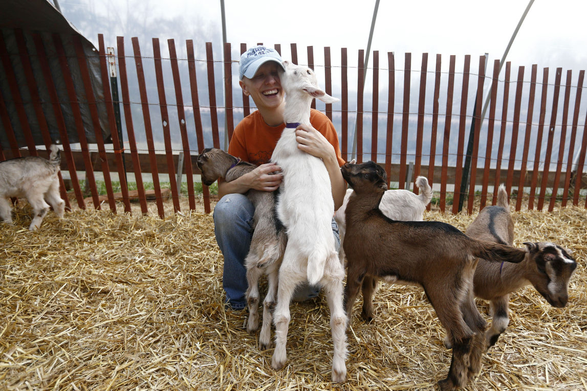 Volunteers cuddle baby goats at Caromont Farm Galleries