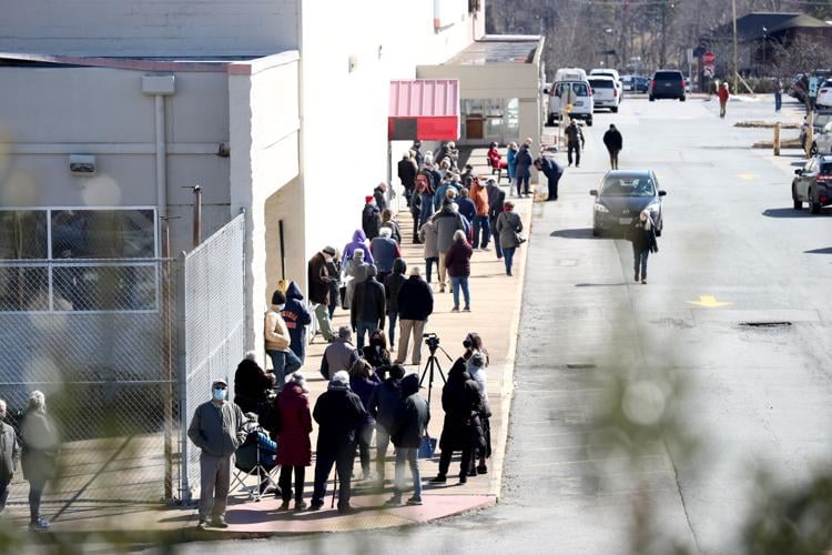 Vaccine recipients wait in line for hours as registration glitch causes