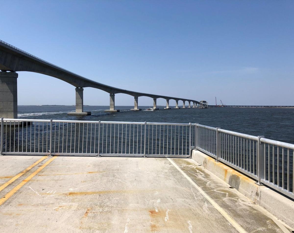 The remains of old Bonner Bridge will become a 1,046 foot-long free fishing pier by this summer. The newer Basnight Bridge spans Oregon Inlet in the background.