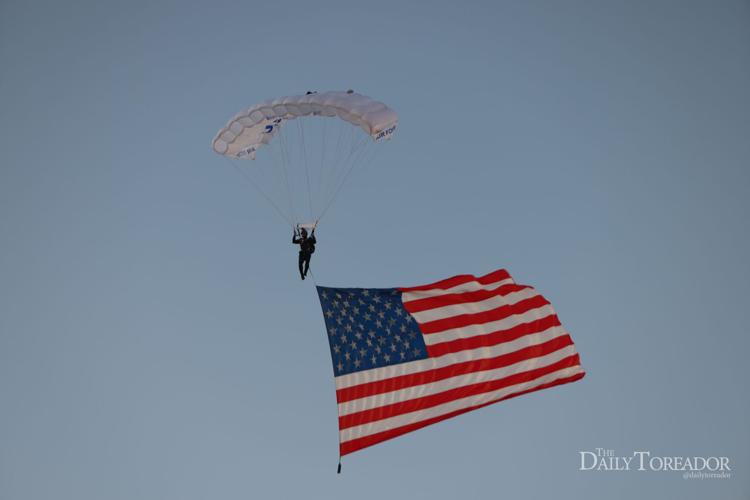 The U.S. Air Force decended from an airlane holding different flag from all the branches