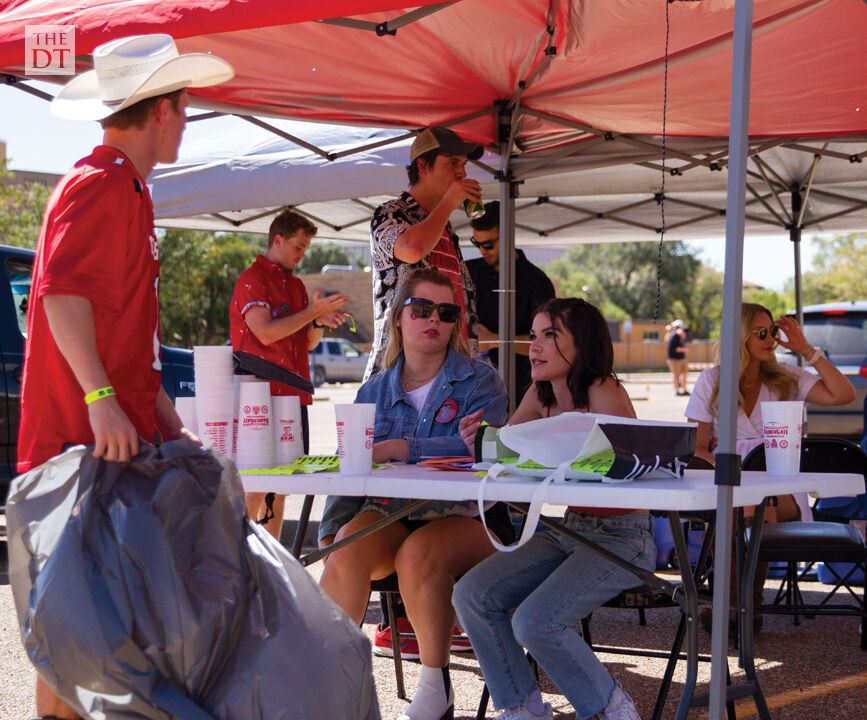 Students talk to others while tailgating