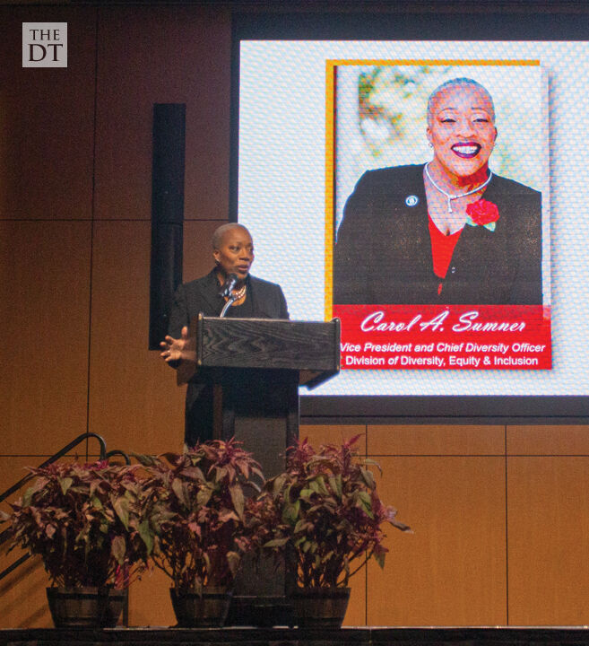 Carol A Sumner welcomes everyone at he Boots, Bows & Rainbow Ties Gala