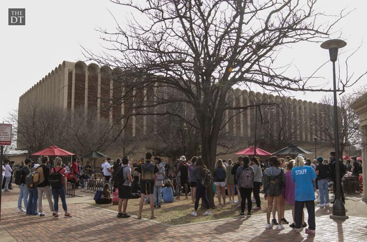 Students listen to Sister Cindy and Brother Jed outside the Student