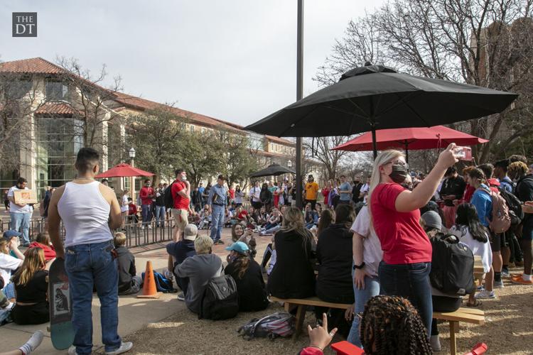 Students listen to Sister Cindy and Brother Jed outside the Student