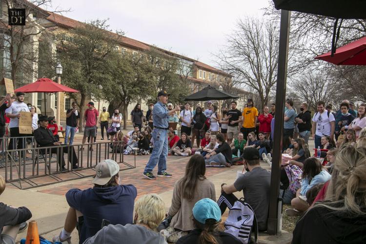 Students listen to Sister Cindy and Brother Jed outside the Student