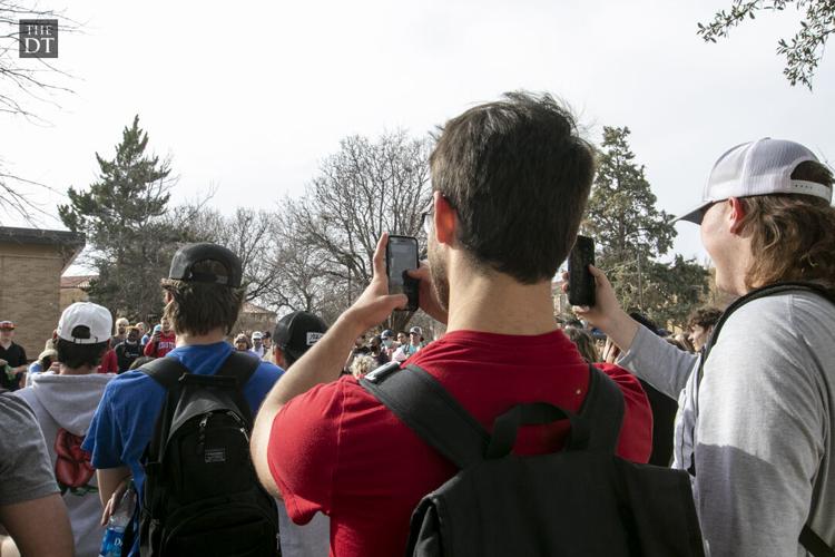 Students listen to Sister Cindy and Brother Jed outside the Student