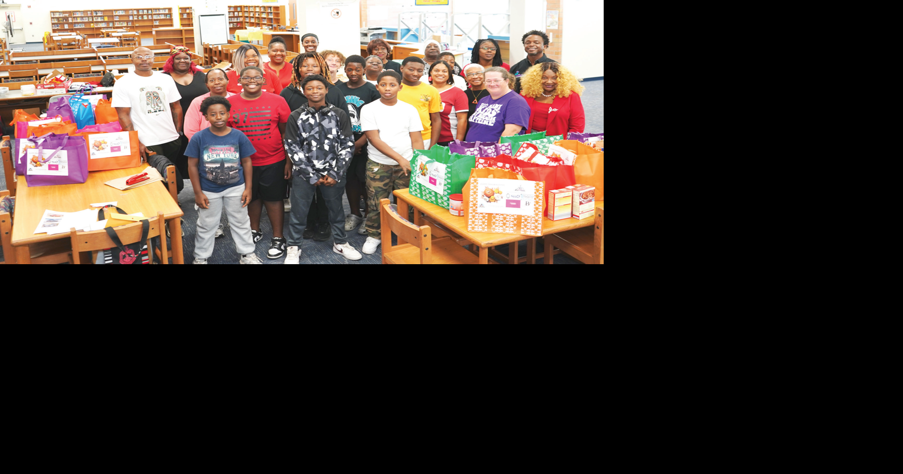 Local boys help to give away food at Campbell Middle School