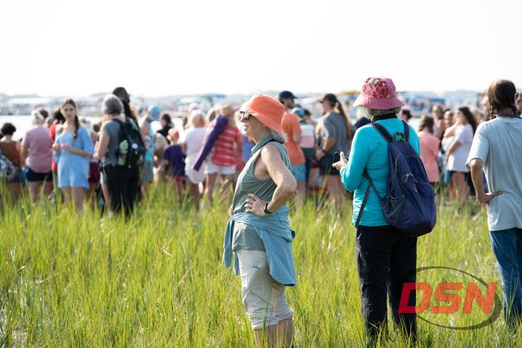 Two women in sun hats chatting in the crowd.jpg