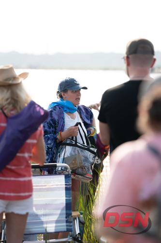 Woman in a captain's hat carrying a bag through the crowd.jpg