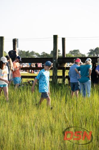 Boy walking through the marsh grass at the Pony Swim.jpg