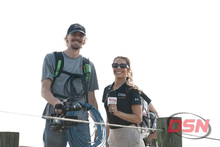 DSN reporter and cameraman smiling on the dock.jpg
