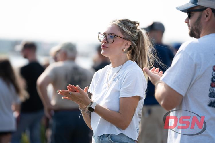 Woman clapping while watching the event by the water.jpg