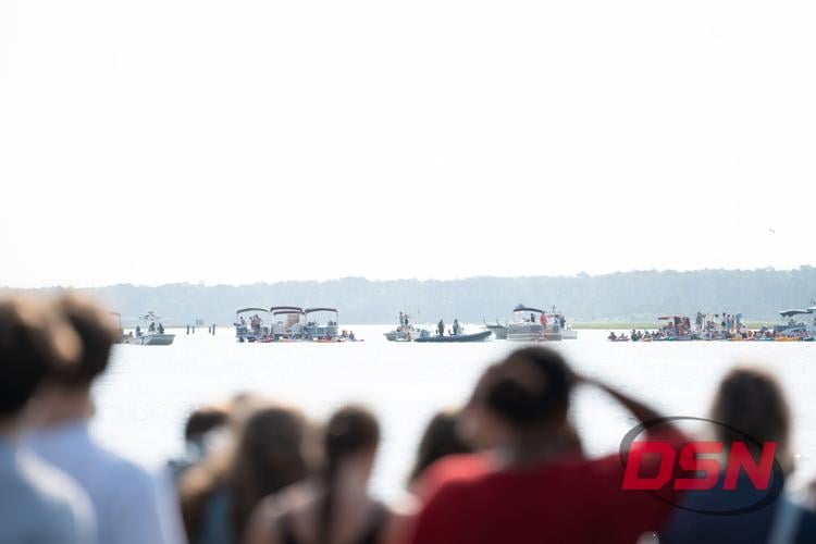 Boats and kayaks lined up in the channel to watch the swim.jpg