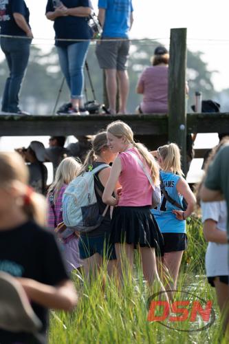 Girls in skirts chatting in the marsh water.jpg