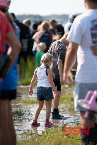 Girl with a braid walking through the muddy marsh water.jpg
