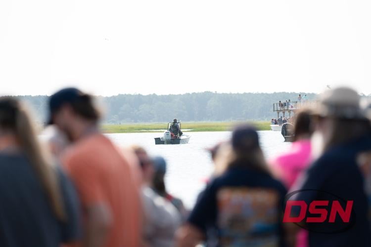 Boat waiting in the channel over the crowd's heads.jpg